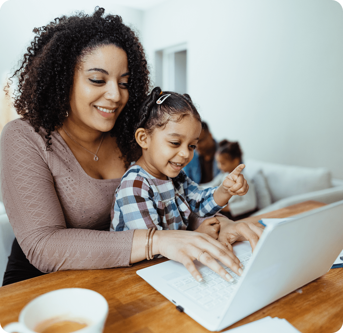 Smiling family at home with computer
