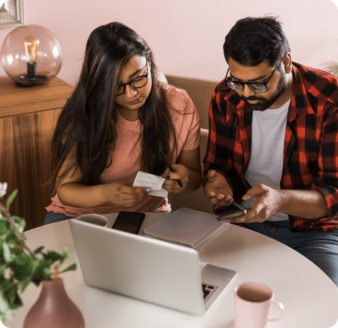 Two people budgeting at home with technology