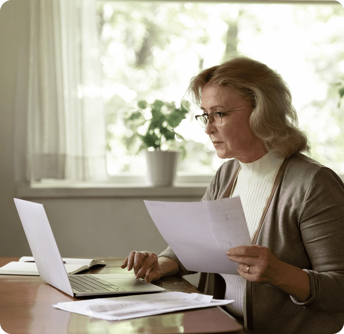 Woman reviewing documents at home office