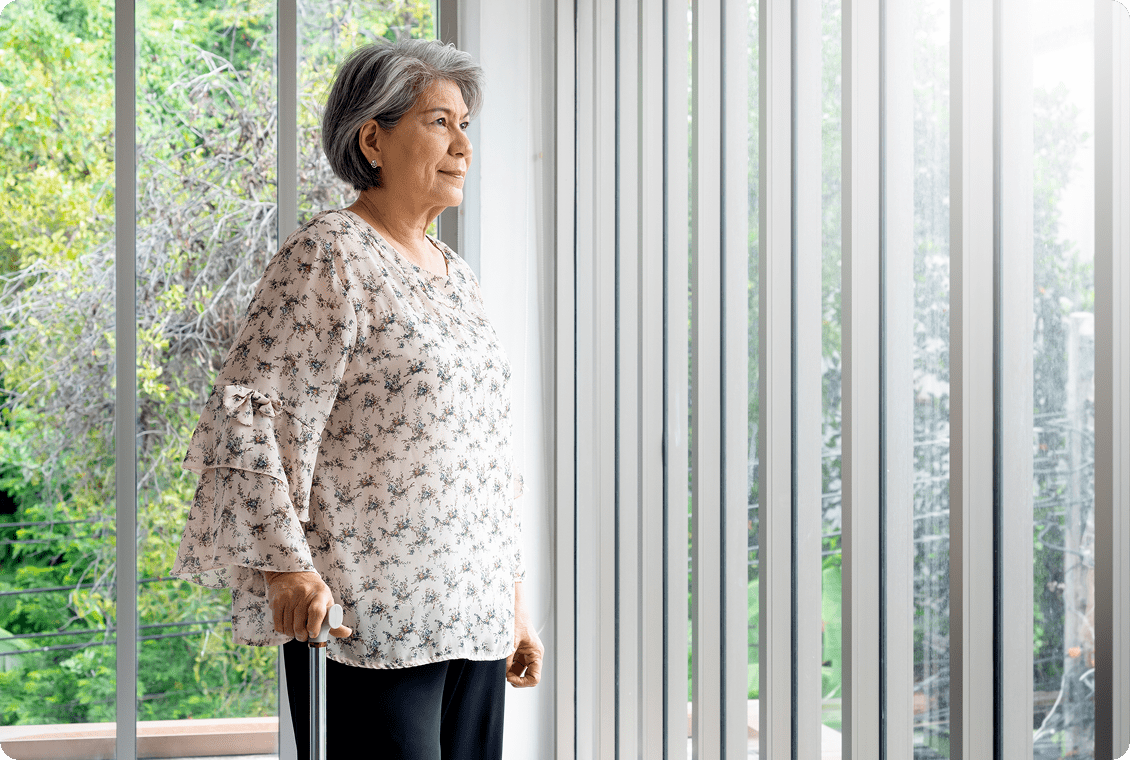 Senior woman gazing outside thoughtfully